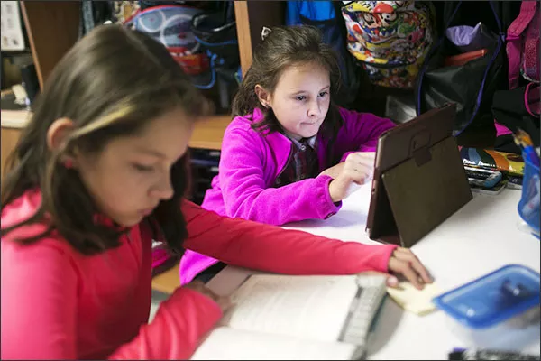 Both printed texts and digital readers have their places in a 3rd grade classroom at Indian Run Elementary School in Dublin, Ohio.
