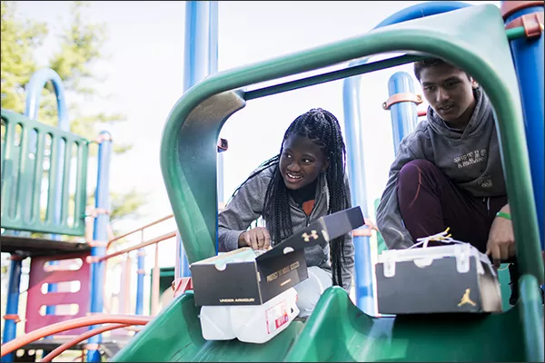 Students Destini Williams and Amrose Bhujel test vehicles they’ve made from trash at Woodward Park Middle School in Columbus, Ohio.