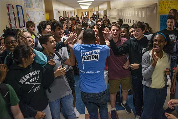 Algebra Nation study expert Darnell Boursiquot high fives Polo Park Middle School students as he makes his way through a hallway on May 24 at the Wellington, Fla., school.